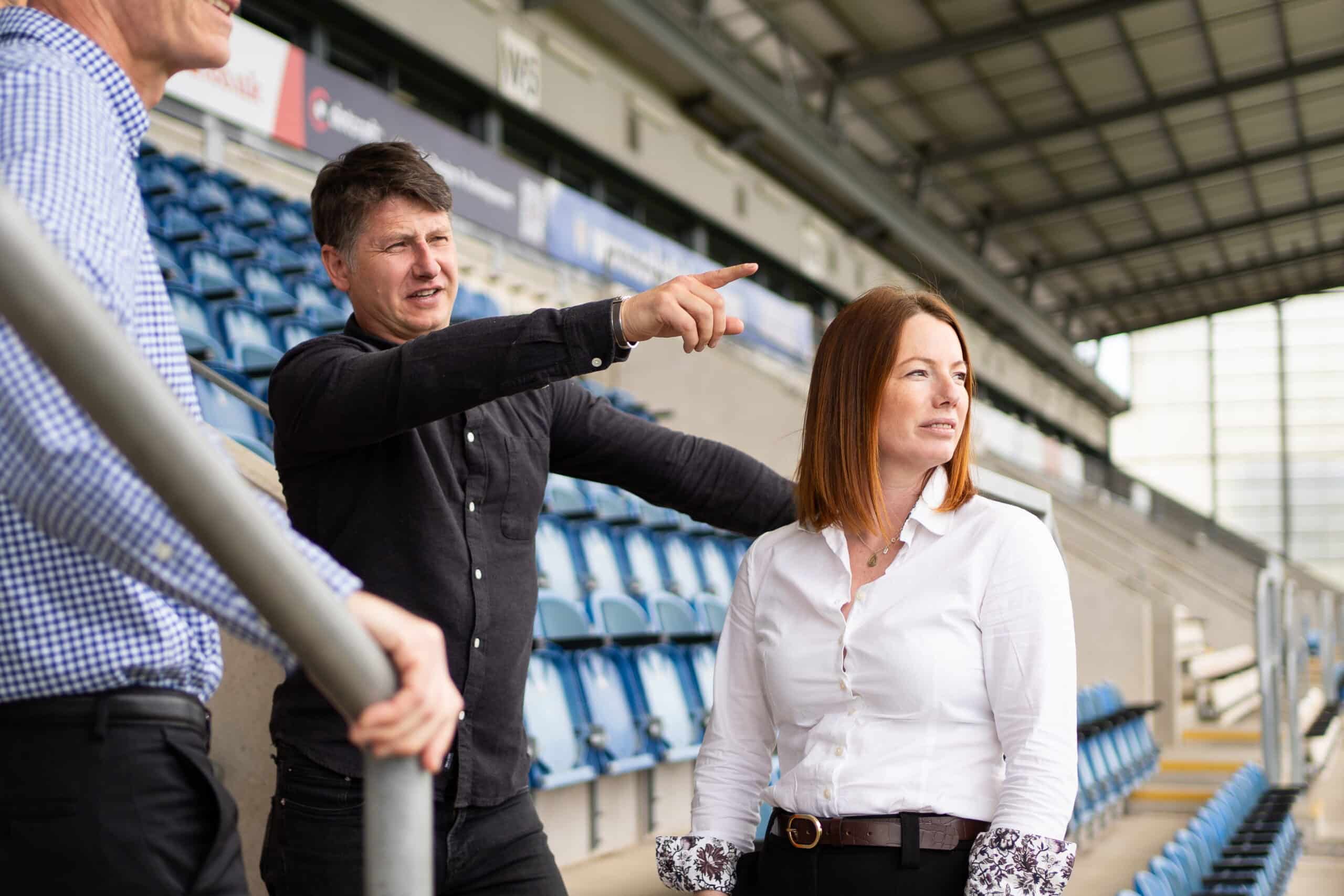 Chris and Emma from The Evacuation Company discussing evacuation with a client in a stadium environment | Access Audit