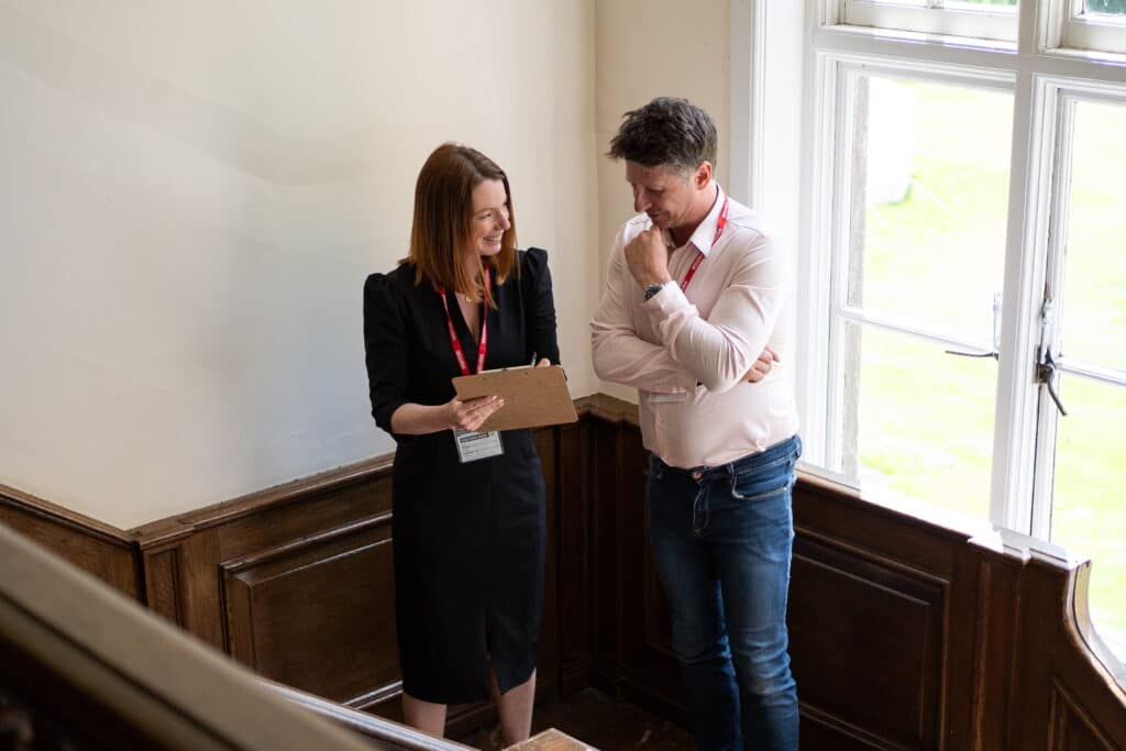 Chris and Emma from The Evacuation Company conducting an equipment access audit for a client on a staircase | Evacuation Specialists